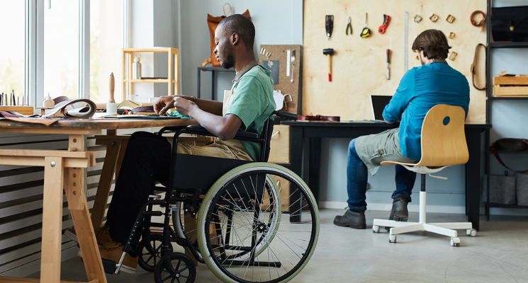 African american man wheelchair making bags