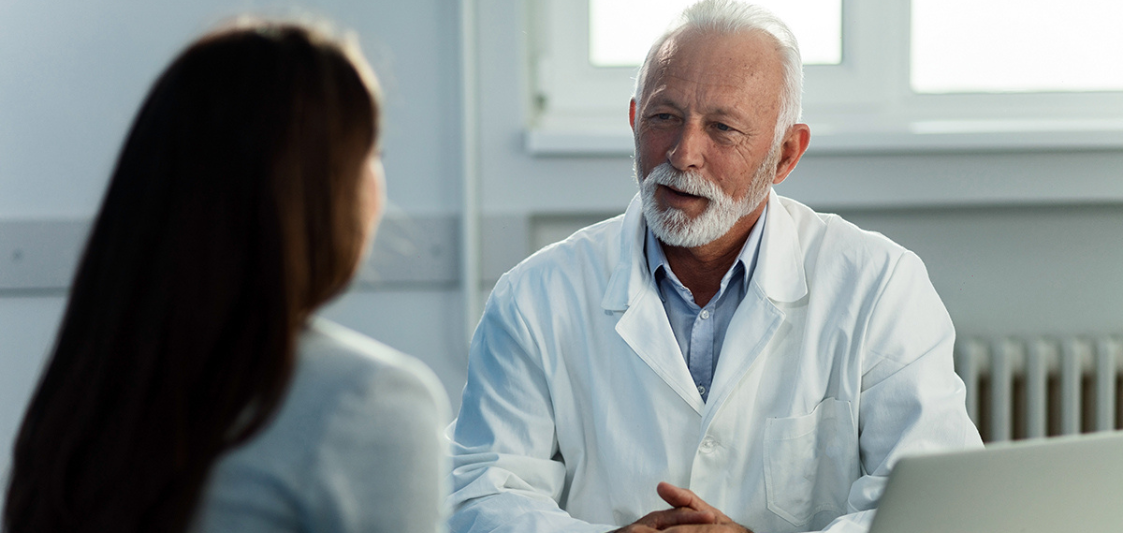 Doctors asking question with female patient