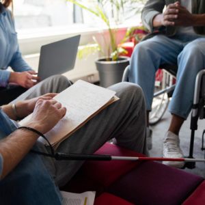 Man on wheelchair doing office job