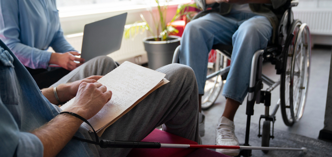 Man on wheelchair doing office job